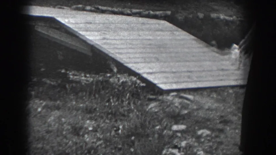 A wooden footbridge spans a small stream or channel in the Reading, Pennsylvania outdoor home-movie scene.