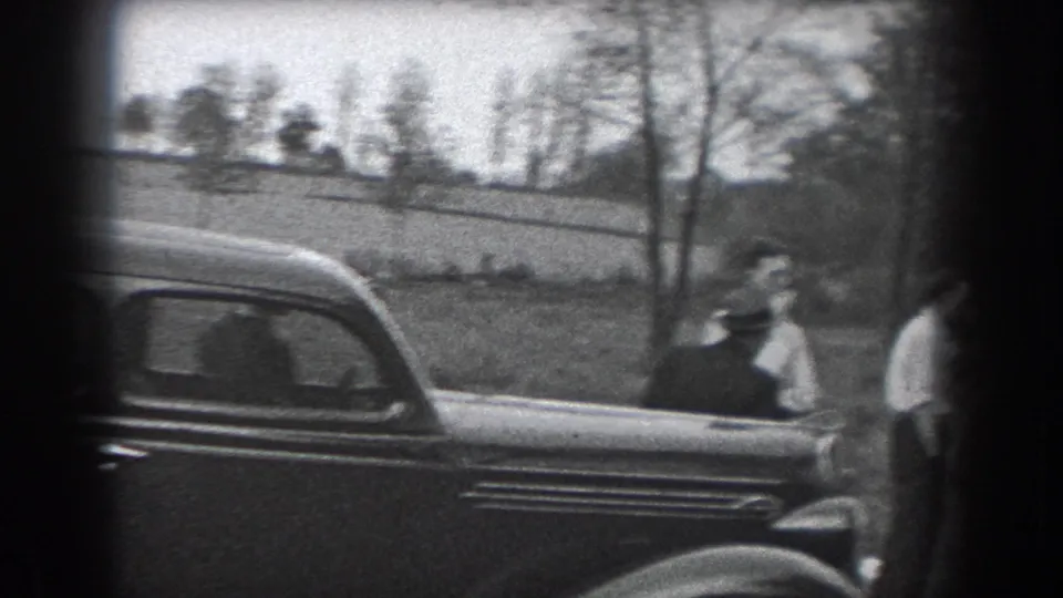 Dark rounded-body car and several men are visible outdoors in the Reading, Pennsylvania home-movie footage.