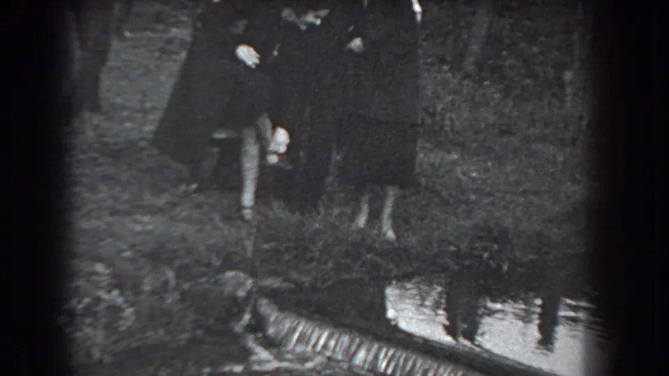 Adults in formal dark coats appear close together outdoors during the Reading, Pennsylvania community gathering.
