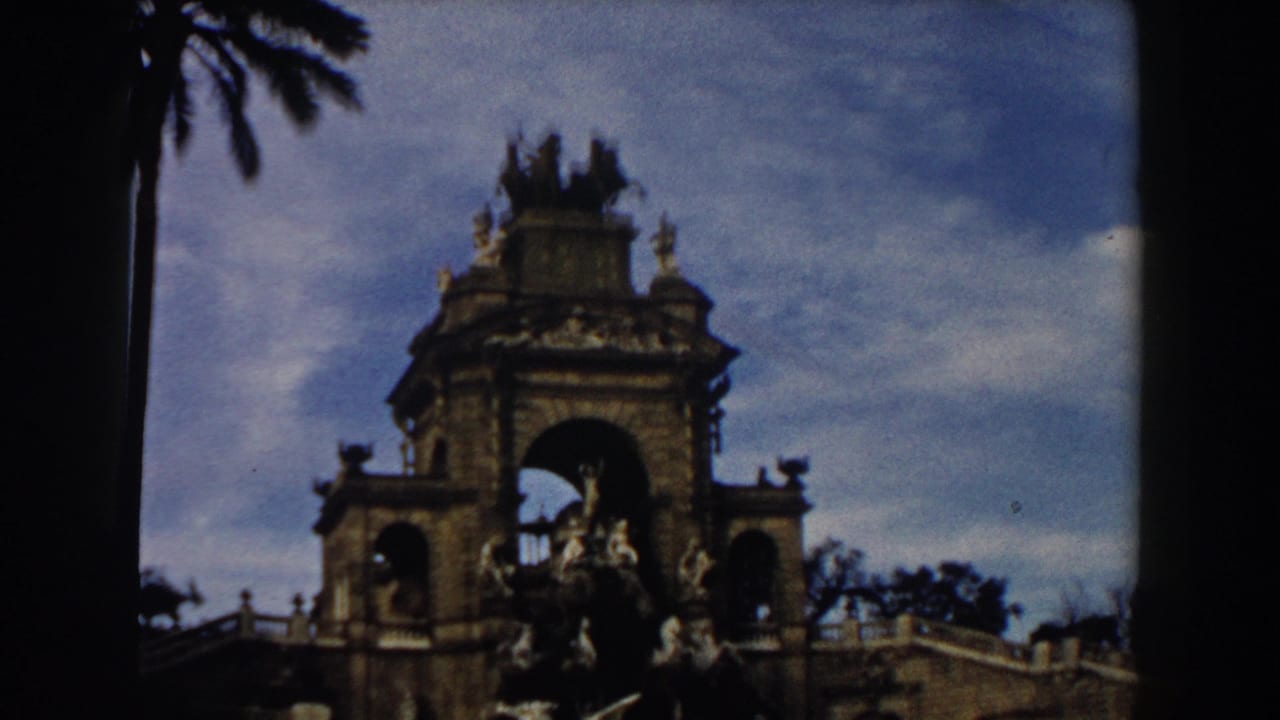 Ornate monument with central arch and sculptural figures against sky.