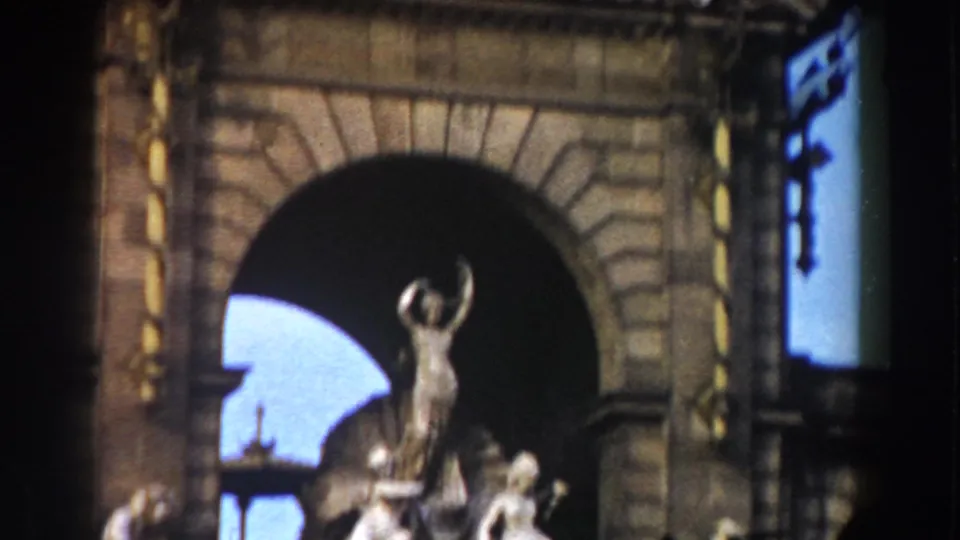 1959 Barcelona frame showing a historic stone arch with a standing statue visible through the large opening.