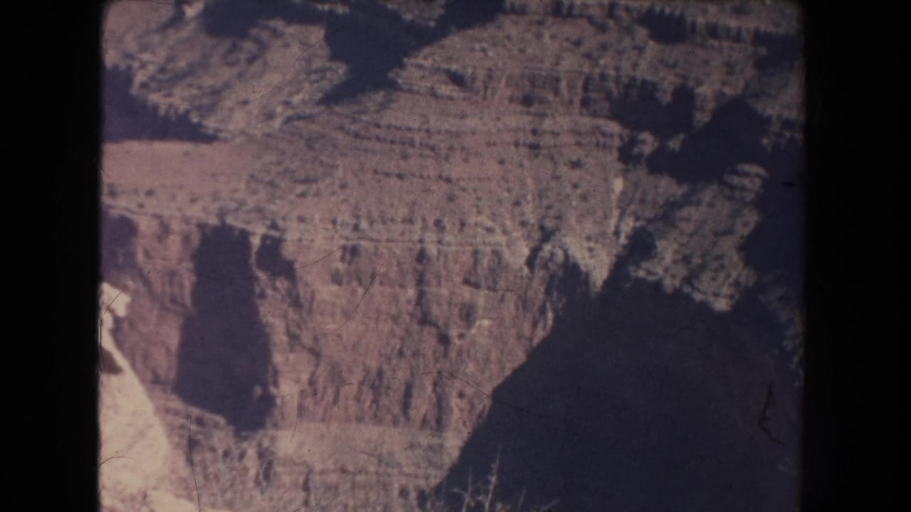 High canyon rim with stratified cliffs and shadowed ravines.