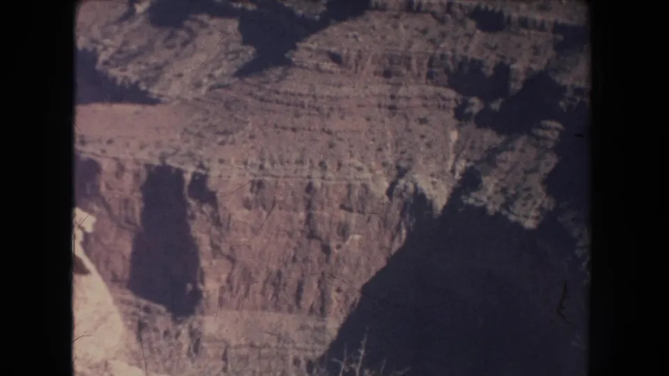A 1951 canyon view shows ridged cliff layers, a broad rim, and deep dark shadows across the rock.