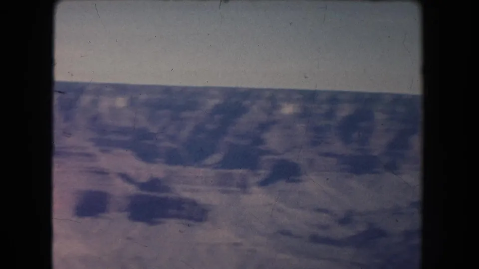 Wide 1951 home-movie view of a desert canyon landscape in New Mexico, with muted color and visible film wear.