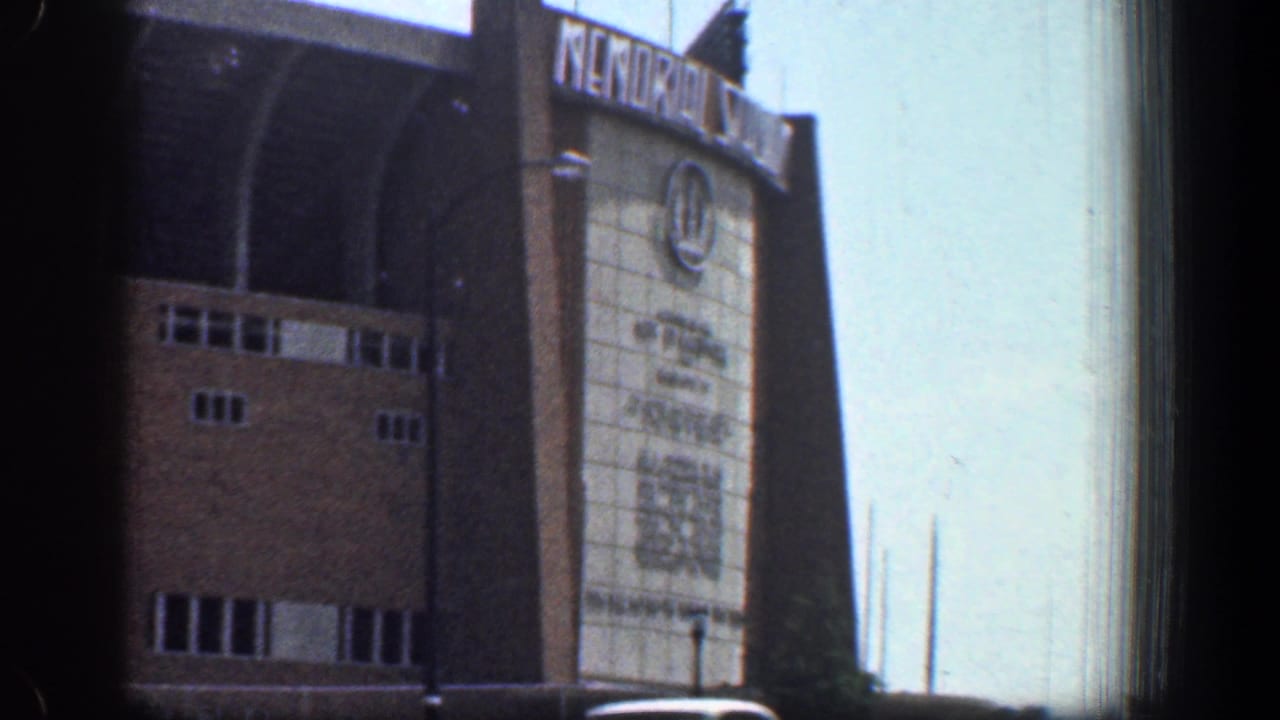 1961 Washington DC frame showing the brick facade of Memorial Stadium with large signage and arched architectural details.