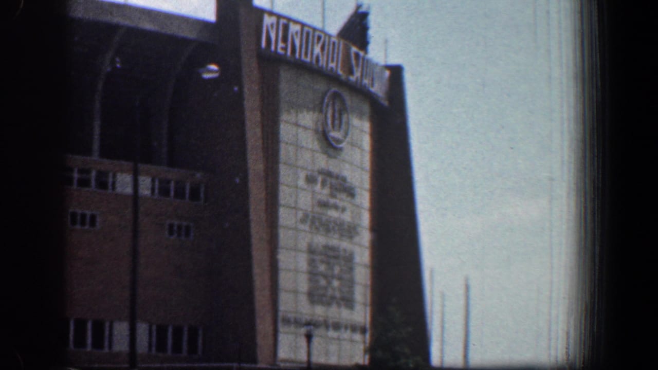 1961 Washington, DC 8mm view of Memorial Stadium entrance signage, brick walls, arched openings, and pale facade panels.