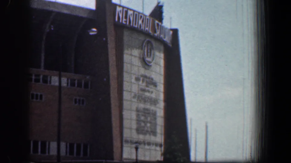 1961 Washington, DC 8mm view of Memorial Stadium entrance signage, brick walls, arched openings, and pale facade panels.