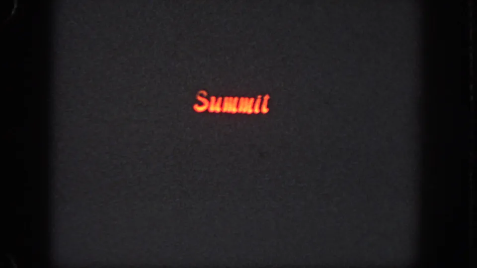 Red script-style Summit logo appears against a dark, grainy 8mm frame from the Georgia 1951 clip.