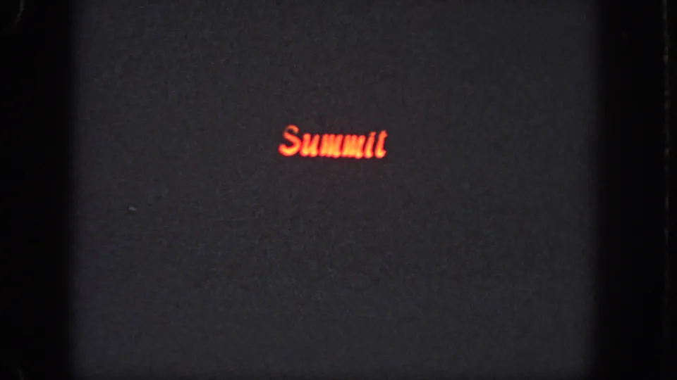 The red Summit logo remains visible on a dark 8mm frame, with grain and soft exposure dominating the image.