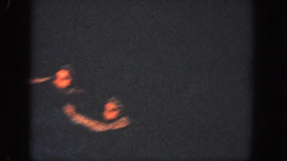 Two swimmers surface in a low-light Georgia pool, their arms blurred by motion during the 1951 routine.