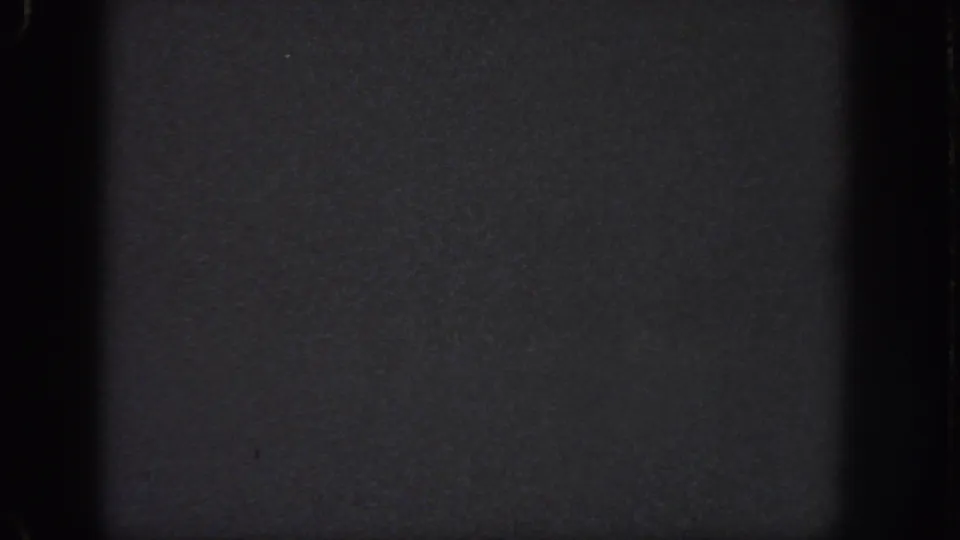 Underexposed 1951 Georgia-sourced 8mm frame showing grain, gate-edge shadowing, and a faint horizontal division.