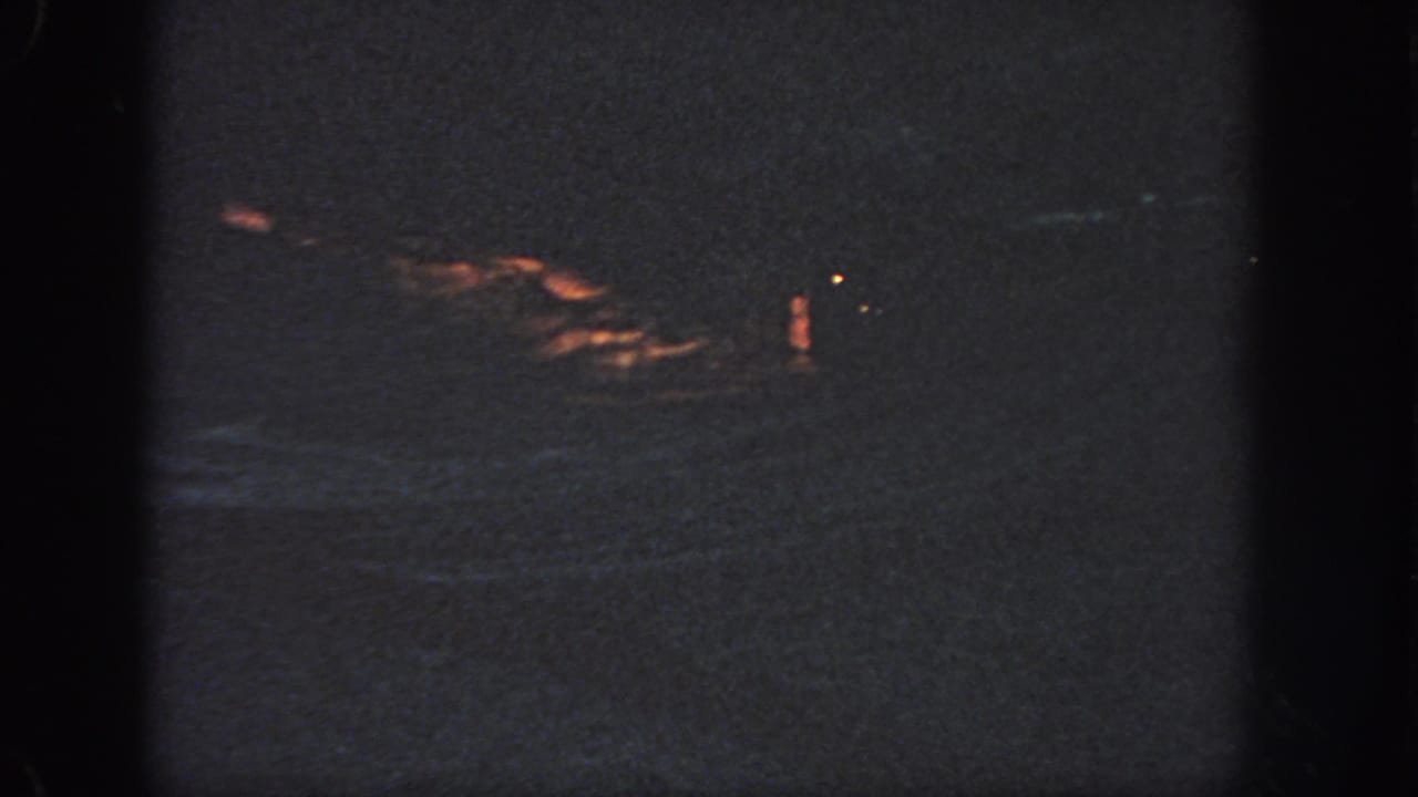1951 Georgia footage metadata supports a dark offshore night scene with a distant orange flotation shape on rough water.