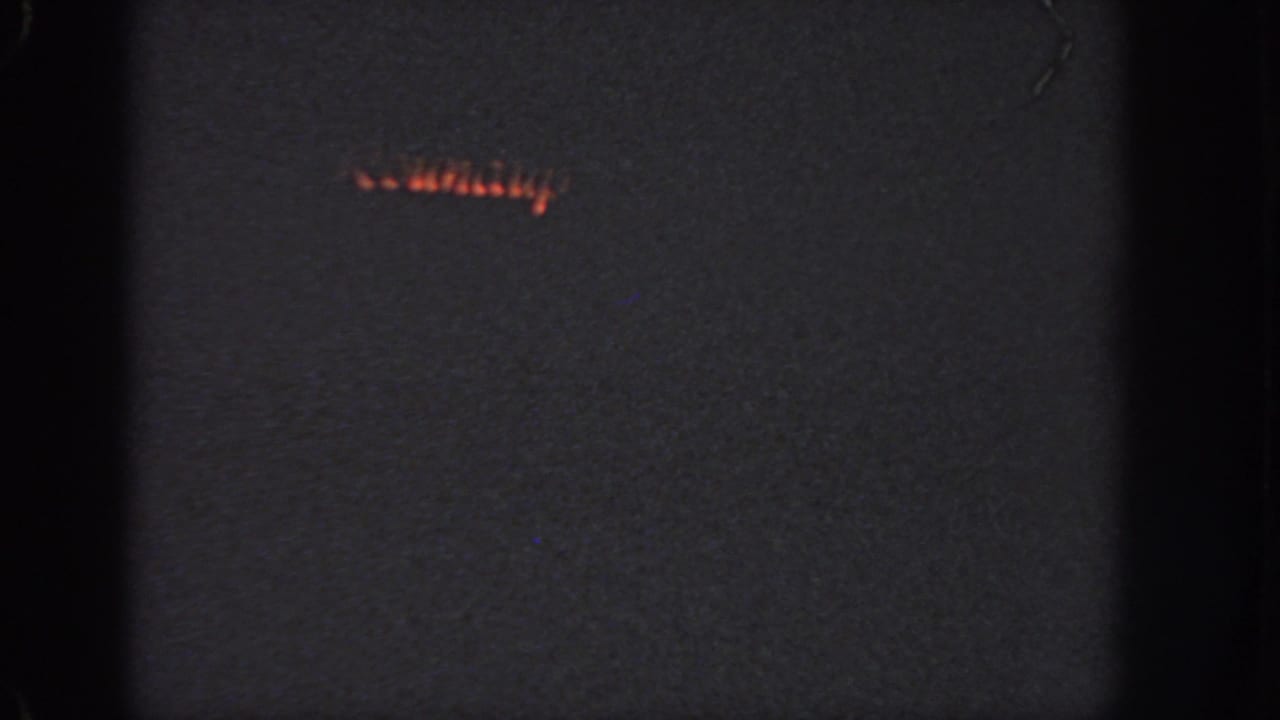A small band of orange light suggests the swimmer continuing across dark water in the final 1951 Georgia frame.