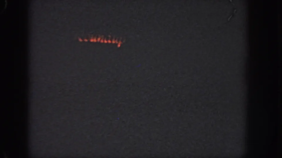 A small band of orange light suggests the swimmer continuing across dark water in the final 1951 Georgia frame.