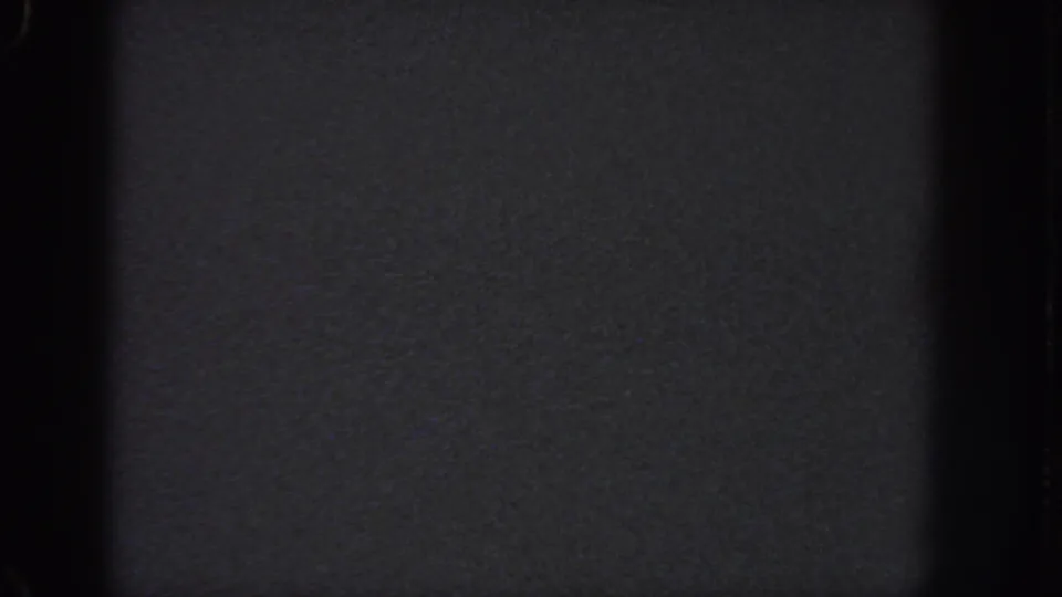 Dark 1951 Georgia 8mm frame with coarse grain, black border areas, and no identifiable imagery.