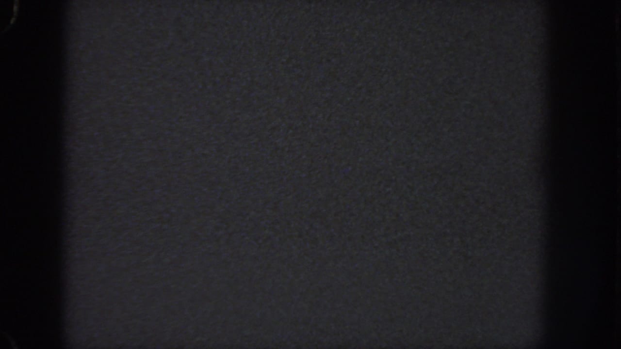Dark 1951 Georgia 8mm home-movie frame with grain, vignetting, and no discernible people, objects, or location detail.