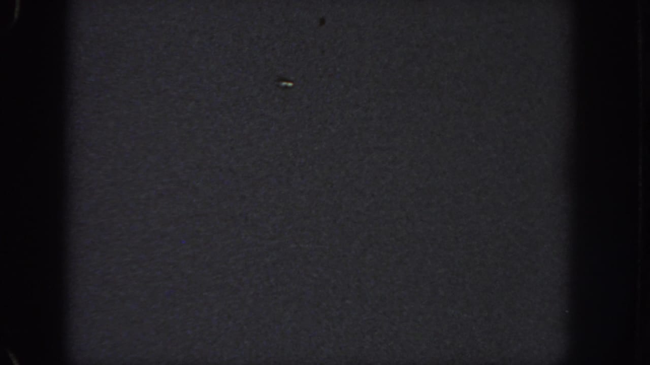 Very dark 1951 Georgia 8mm frame with mostly black exposure, visible grain, and contact-sheet frame edges.