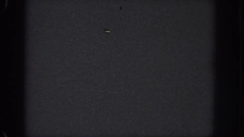 Very dark 1951 Georgia 8mm frame with mostly black exposure, visible grain, and contact-sheet frame edges.