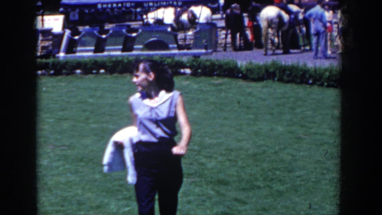 A woman in sleeveless clothing is seen on the lawn at French Lick, with resort guests and a Sheraton Unlimited sign in the background.