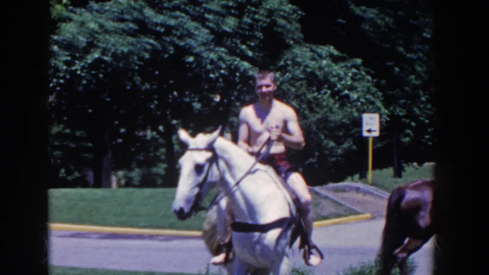A front-facing view shows the man holding the reins as the white horse walks toward the camera in French Lick.