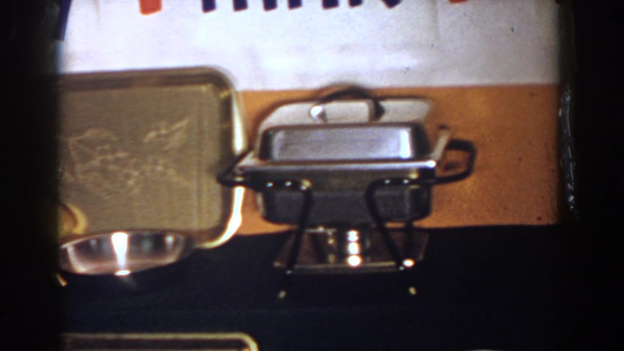 1958 French Lick frame with a chafing dish, silver tray, china, and partial lettering above the table.