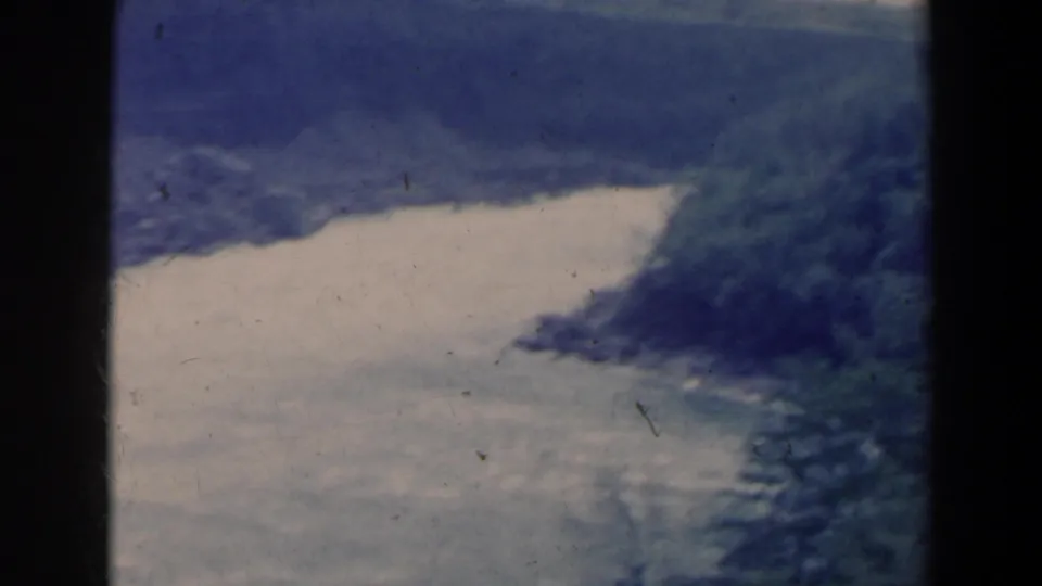 1963 home-movie view of a broad river between forested slopes, likely near Niagara Falls, Canada, with visible 8mm grain and faded color.