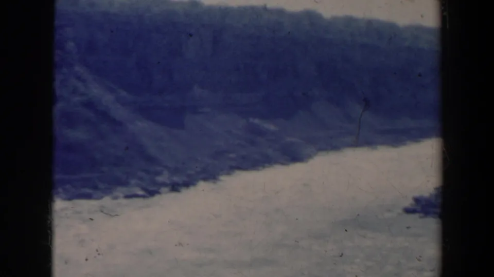 Faded 1963 8mm view of river water and dark forested shorelines in the Niagara Falls, Canada area, with scratches and dust visible.