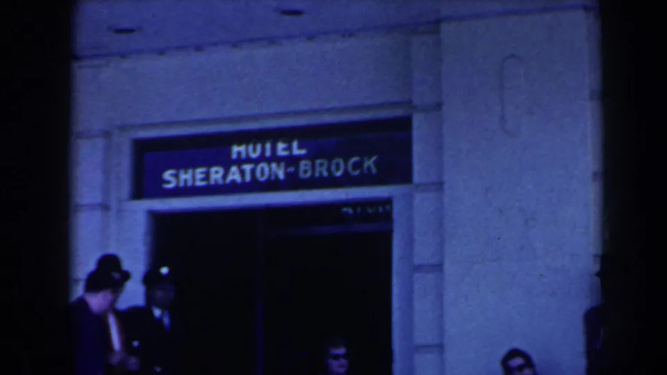 Hotel Sheraton-Brock entrance in Niagara Falls, Canada, with guests gathered beneath the visible sign.