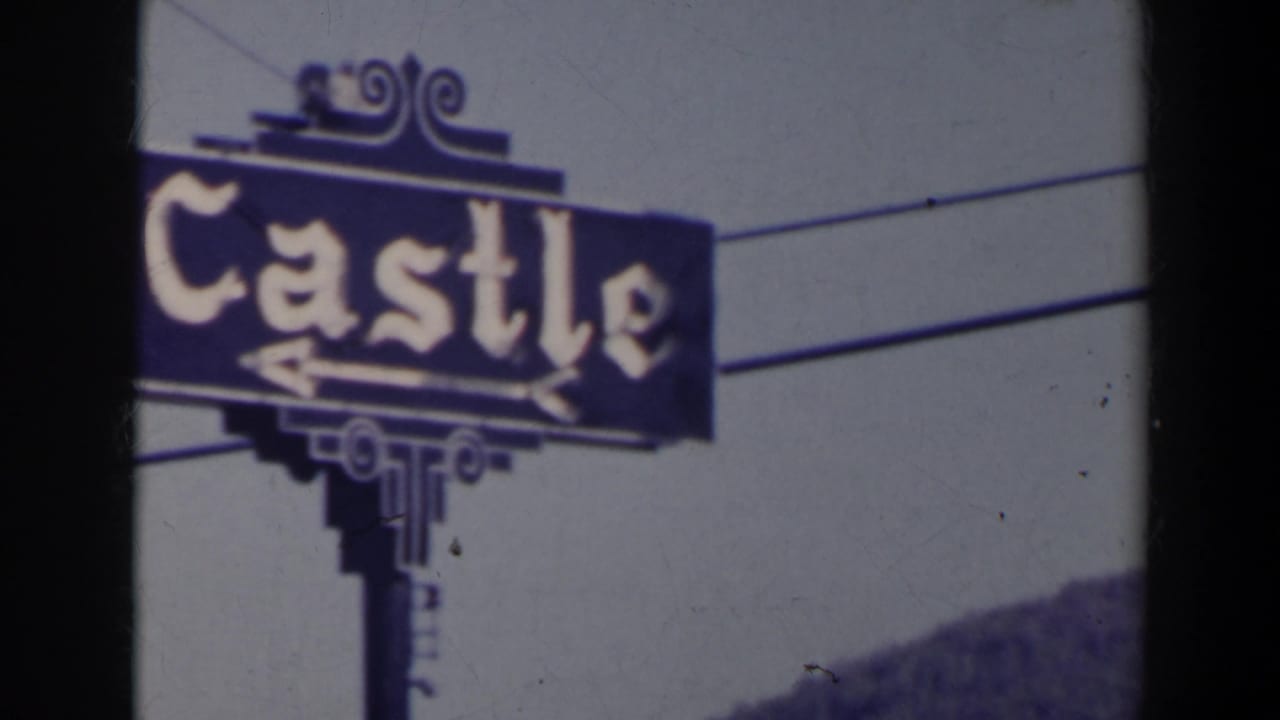 Closer view of the Castle sign with ornate lettering and overhead wires.