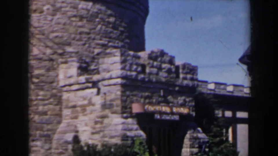 The final frame emphasizes the stonework and partially legible cocktail lounge signage on the building exterior.