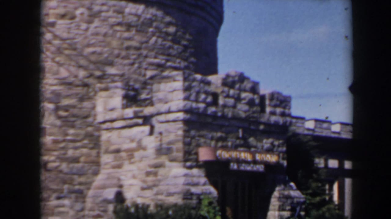 1963 Niagara Falls area home-movie frame showing stone castle-style architecture with a sign reading Cocktail Lounge and The Concorde.