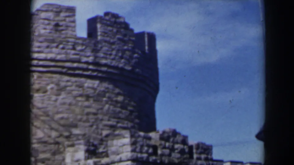1963 8mm frame focusing on the crenellated top of a castle-like stone tower near Niagara Falls, Canada.