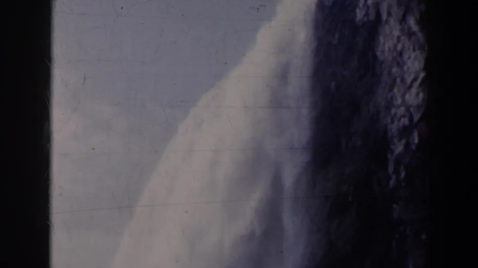 Likely Niagara Falls, Canada, in a 1963 8mm frame showing white water against dark rock and pale sky.