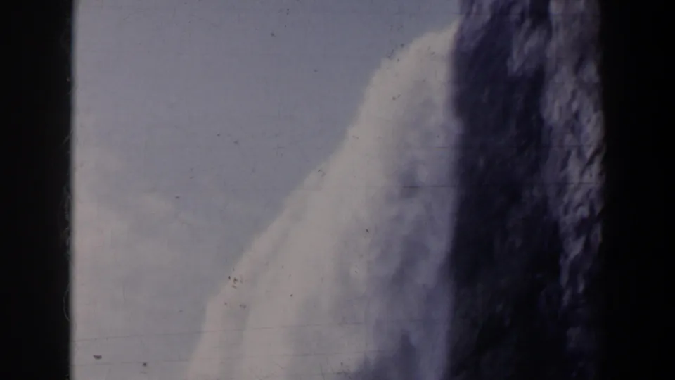Final 1963 8mm frame shows a soft, handheld view of water cascading beside dark rock, likely at Niagara Falls, Canada.