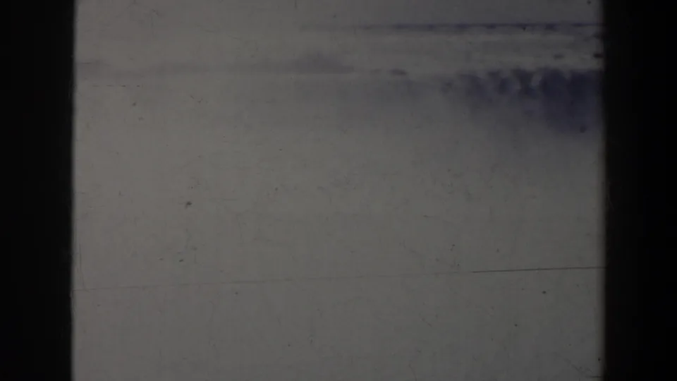 Dark, scratched 8mm opening frame from the 1963 Niagara Falls Canada clip, with little readable scenery visible.
