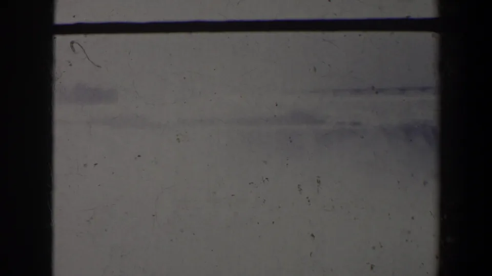 Hazy 8mm frame with a dark vertical border and faint distant forms, likely part of the Niagara Falls travel footage.