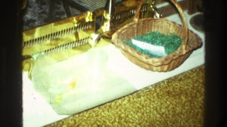 1969 Clarendon Hills kitchen counter with a wicker basket holding green grass-like material beside a white board and golden decorative object.