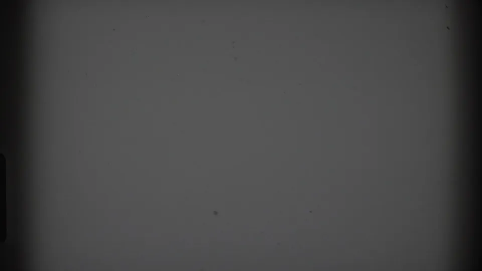 A dark, grainy 8mm frame with a gray upper field and minimal visible detail at the start of the 1969 home-movie clip.