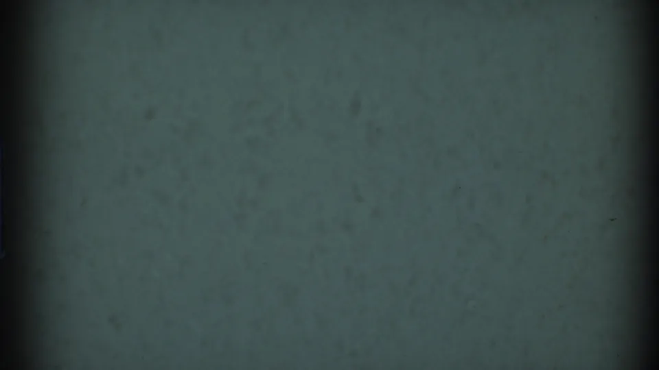 Muted green-gray 8mm reel-start frame from the 1969 Clarendon Hills home-movie clip, with grain and dark vertical edge shading.