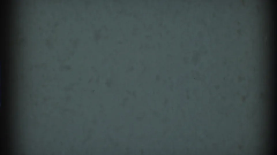Blank 8mm-style frame from the 1969 Clarendon Hills clip, showing muted film texture, grain, and a dark vertical gate shadow.