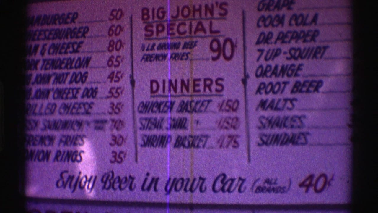 Purple-tinted 8mm frame showing the Nebraska fast food menu with burgers, drinks, dinners, and the beer-in-car line.