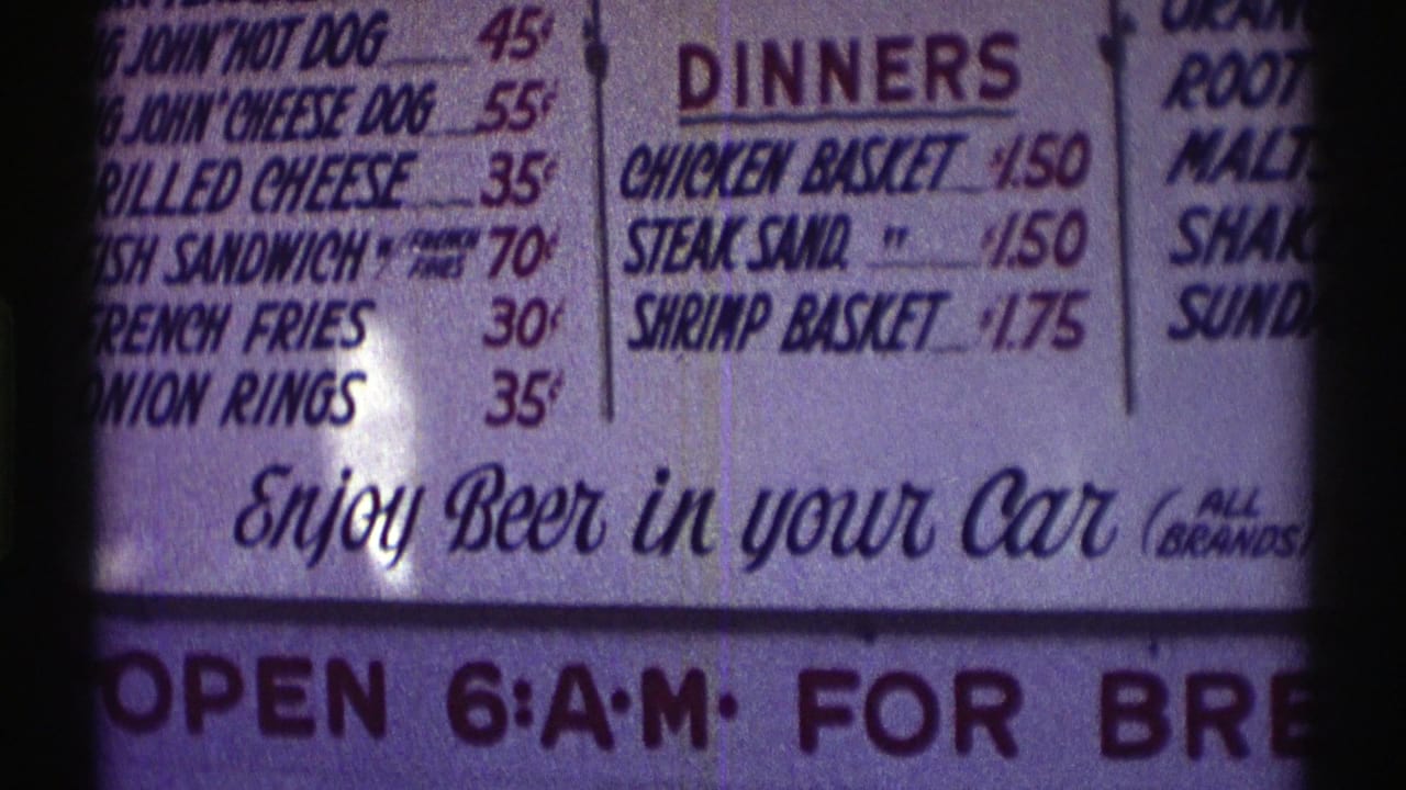 Menu board section with sandwich listings, dinner prices, and partial beverage items at the edge.