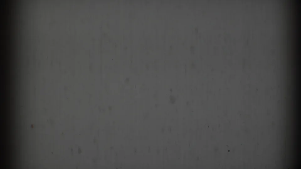 1969 8mm frame from Clarendon Hills metadata showing a plain gray film texture with soft vignetting, vertical shadows, grain, and dust.