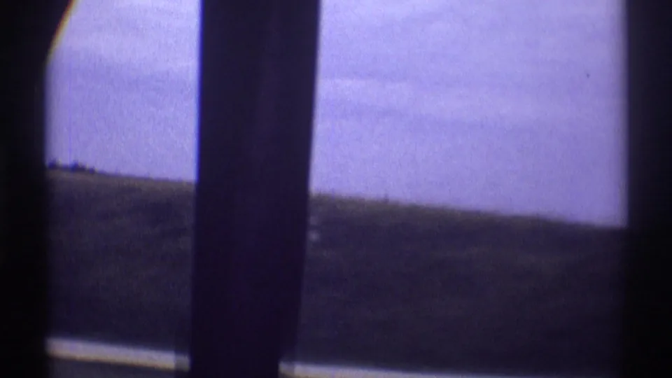 The final frame shows the moving car's vertical interior pillar with rural Illinois fields and a pale sky beyond the window.