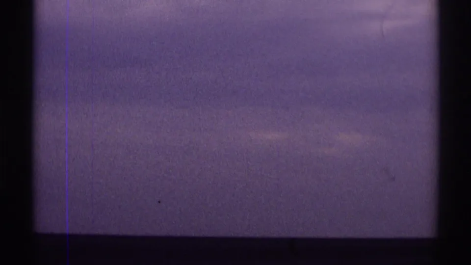 Clouds and purple color shift appear behind dark interior or frame divisions in the road-trip clip.