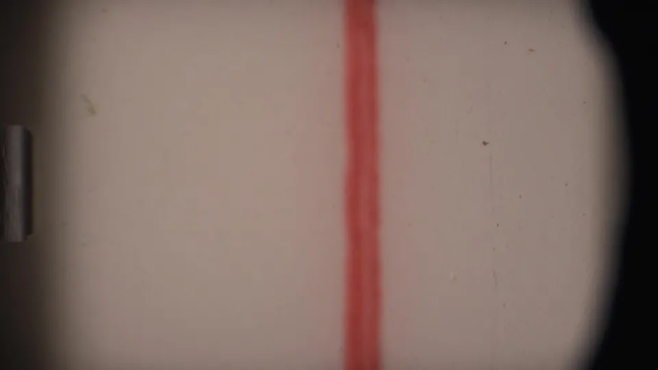 Obscured 1969 Angola 8mm frame dominated by film gate edges, pale exposure, and a red vertical line artifact.