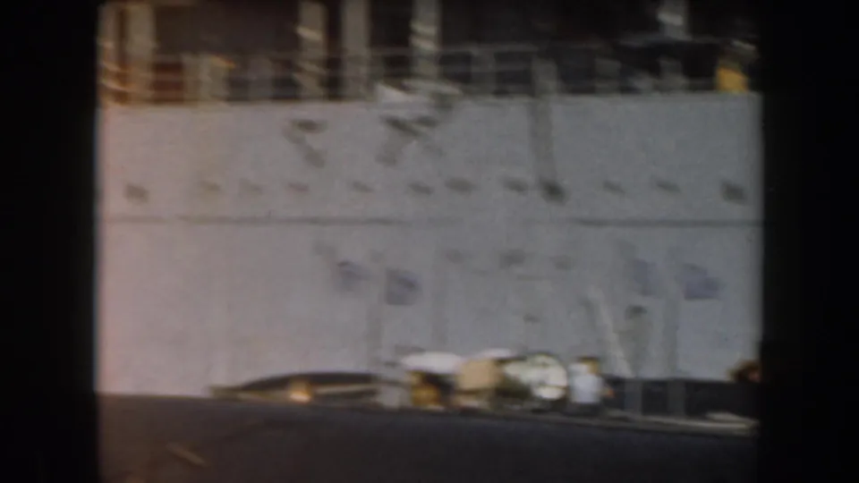 1961 California port footage showing a pale ship side, upper railings, and crew figures near the lower frame.