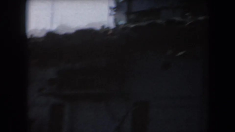 Handheld 1961 California frame with a shadowed naval ship section, railings, and mast lines softened by 8mm motion.