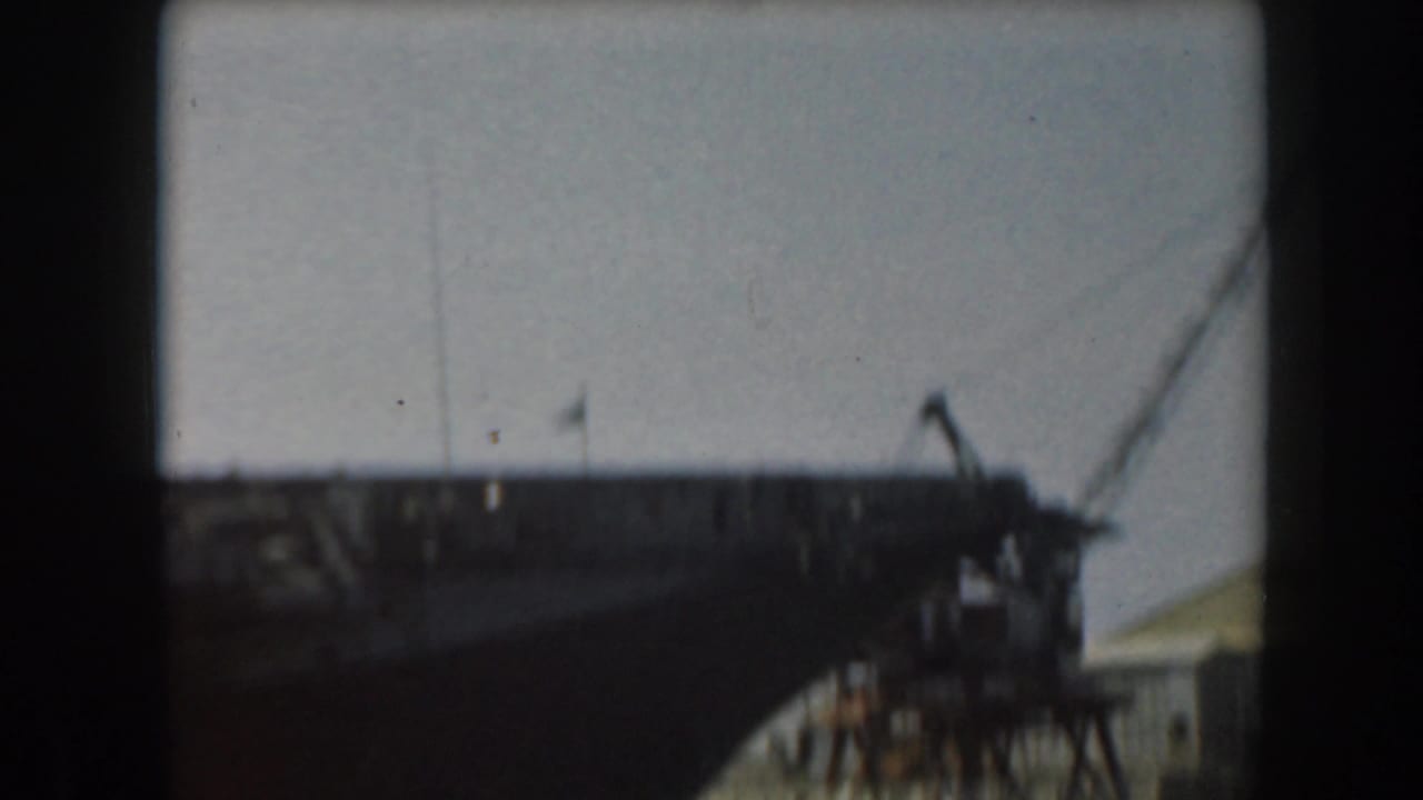 Upper section of a large vessel with rigging or crane lines near the right edge.