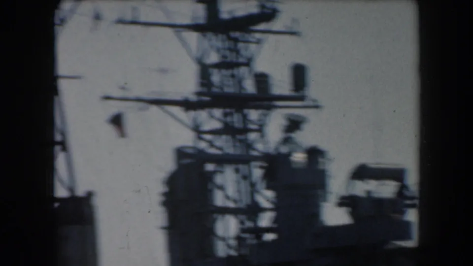 1961 California 8mm frame with a ship mast, antenna arms, and radar-like equipment seen in high-contrast silhouette.